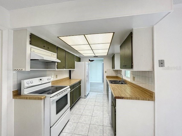 kitchen with light tile patterned flooring, white appliances, backsplash, and sink