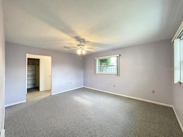 unfurnished bedroom featuring ceiling fan, a closet, and carpet