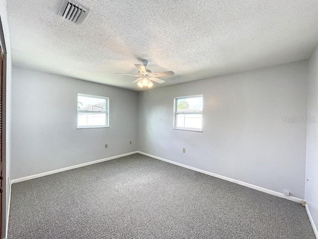 unfurnished room featuring carpet flooring, ceiling fan, and a textured ceiling