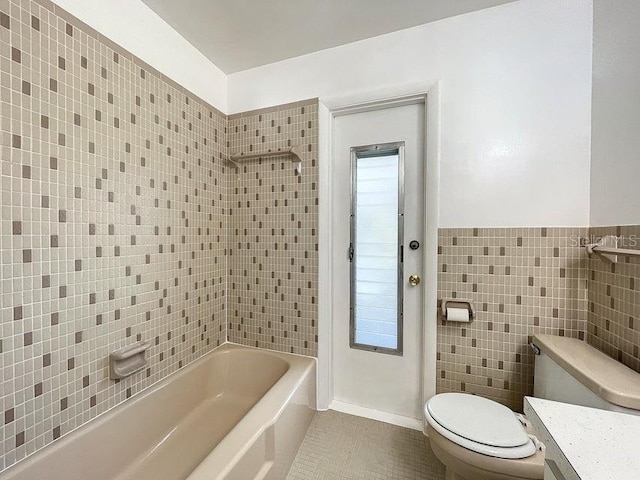 full bathroom with vanity,  shower combination, tile walls, tile patterned flooring, and toilet