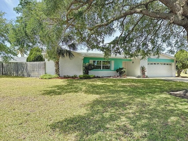 ranch-style house with a garage and a front yard