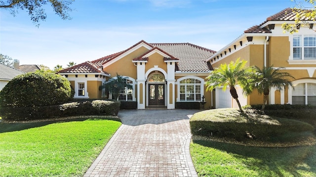 mediterranean / spanish-style house with a front lawn