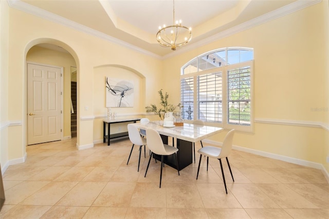 tiled dining room featuring a notable chandelier, a raised ceiling, and crown molding