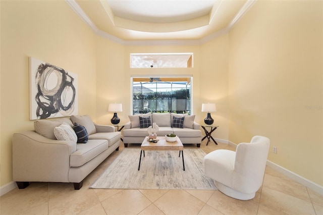 living room featuring light tile patterned floors and a tray ceiling