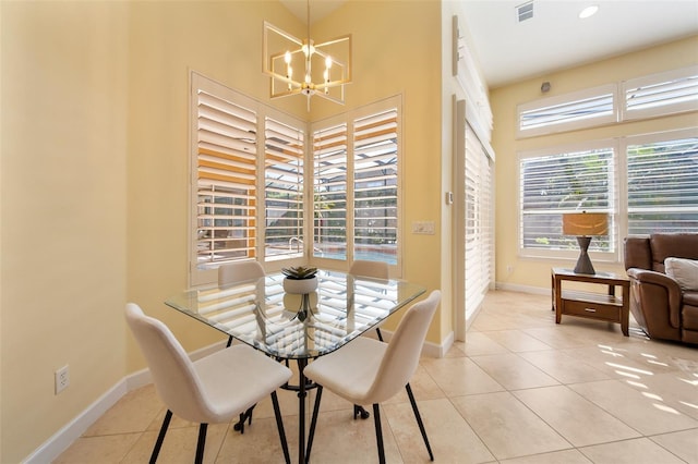 dining room featuring light tile patterned flooring and an inviting chandelier