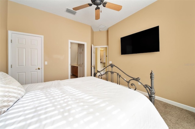 bedroom with ceiling fan, carpet floors, and ensuite bath