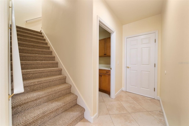 stairway featuring tile patterned flooring