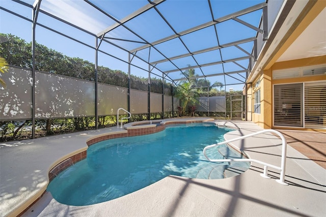 view of pool featuring glass enclosure, a patio area, and an in ground hot tub