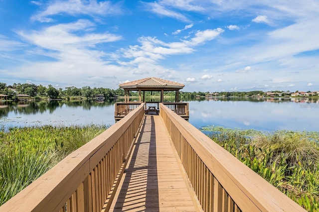 view of dock with a gazebo and a water view