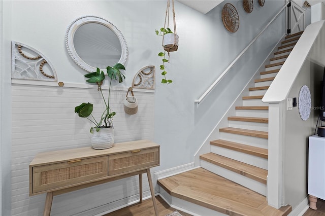 stairs featuring hardwood / wood-style floors