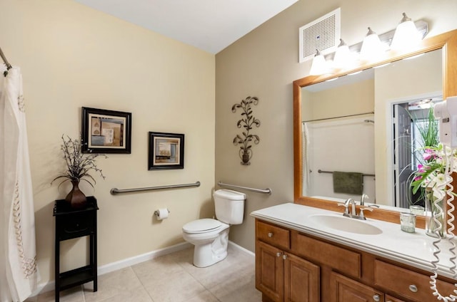 bathroom with tile patterned flooring, vanity, and toilet