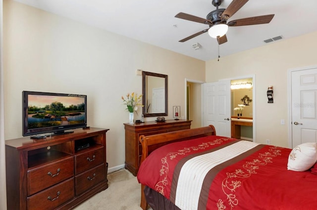 carpeted bedroom with ceiling fan and connected bathroom