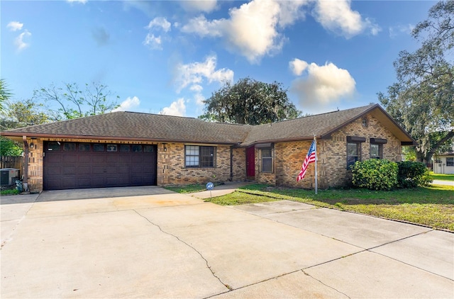 ranch-style house with a garage, a front lawn, and cooling unit