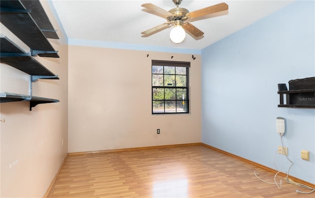 empty room with ceiling fan, a textured ceiling, and light hardwood / wood-style flooring