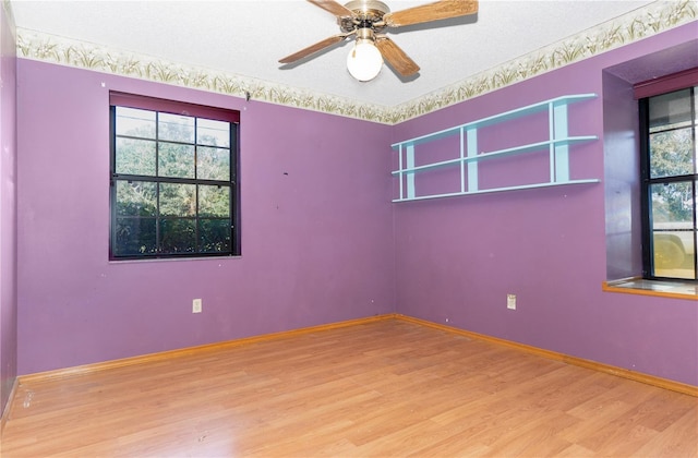 unfurnished room with hardwood / wood-style floors and ceiling fan