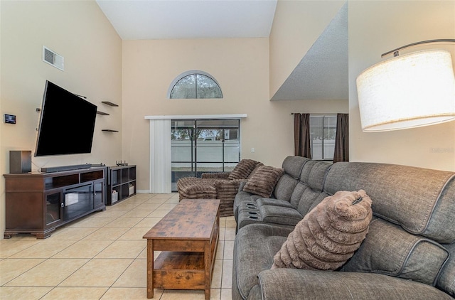 tiled living room with high vaulted ceiling