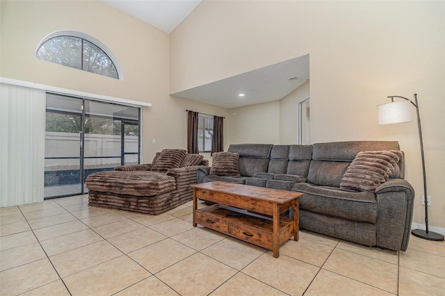 tiled living room featuring a high ceiling