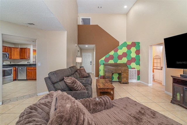 living room featuring a towering ceiling and light tile patterned flooring