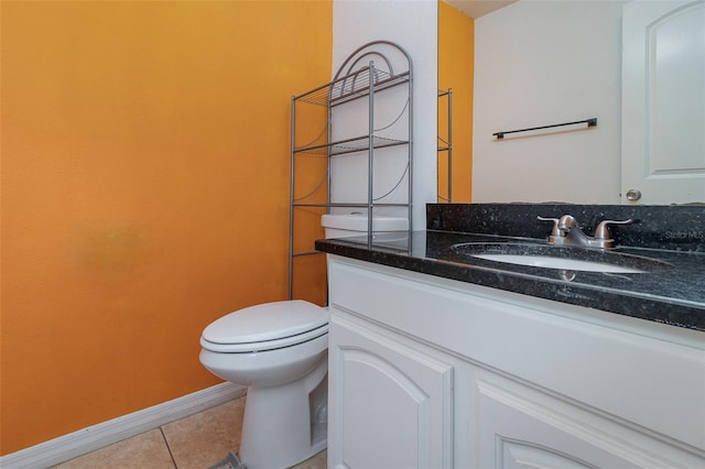 bathroom with toilet, tile patterned floors, and vanity