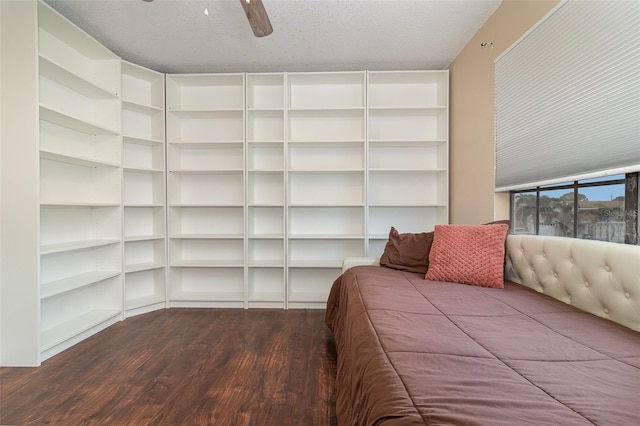 bedroom with ceiling fan, a textured ceiling, and wood-type flooring