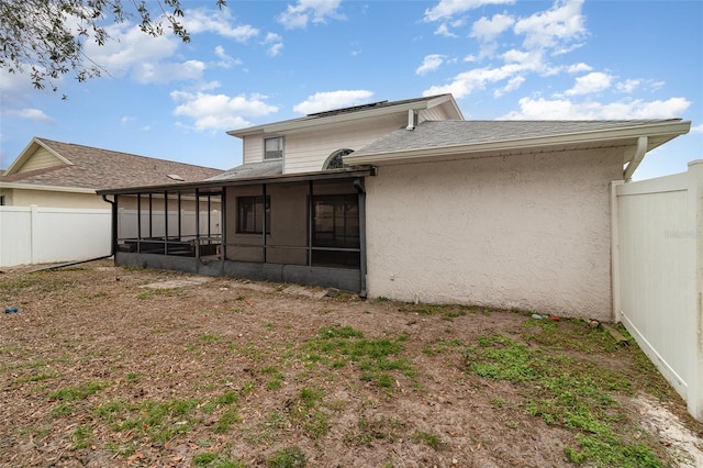 rear view of property with a sunroom