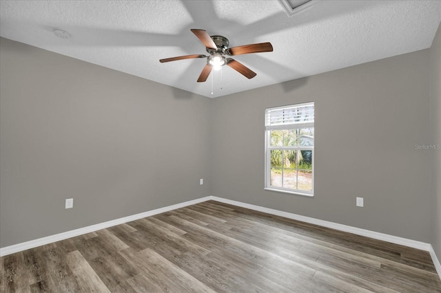 unfurnished room with a textured ceiling, hardwood / wood-style flooring, and ceiling fan