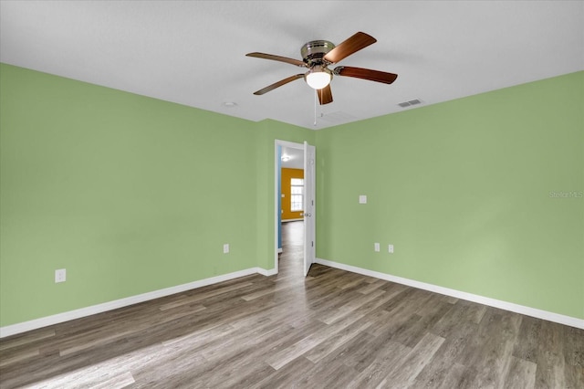 spare room featuring hardwood / wood-style floors and ceiling fan