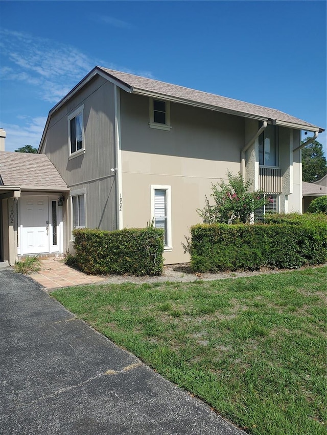 view of side of home featuring a lawn