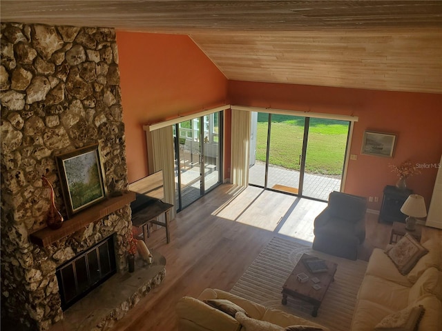 unfurnished living room with hardwood / wood-style flooring, wood ceiling, a fireplace, and vaulted ceiling