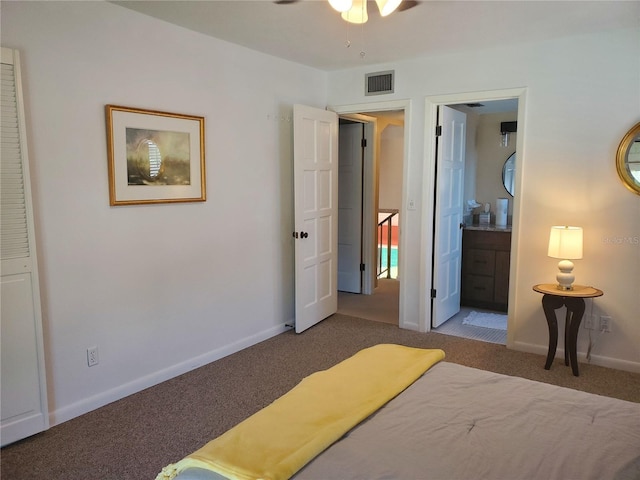 bedroom with carpet flooring and connected bathroom