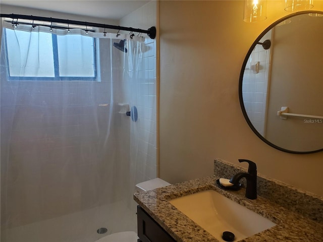 bathroom featuring walk in shower, vanity, and toilet