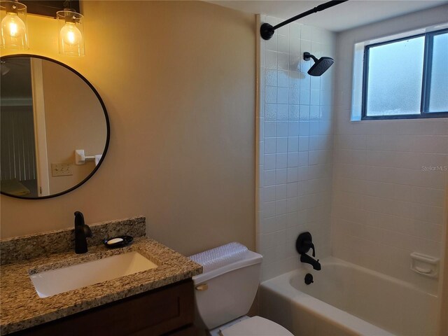 full bathroom featuring vanity, toilet, and tiled shower / bath