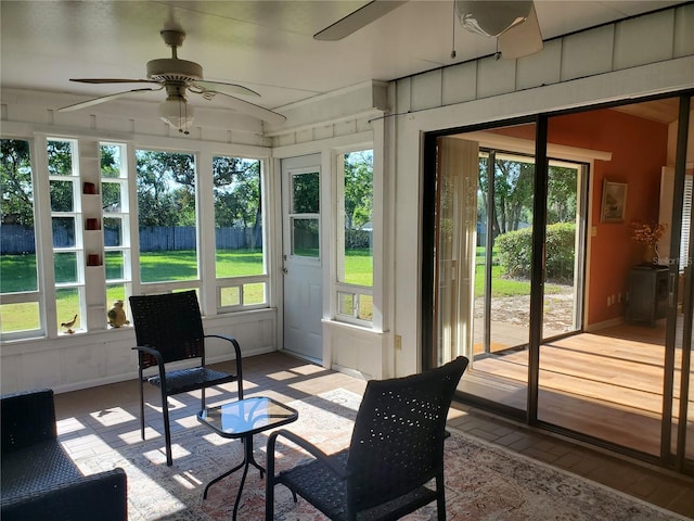 sunroom / solarium with plenty of natural light and ceiling fan