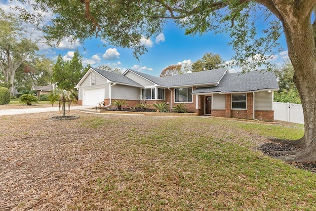 ranch-style house with a garage and a front yard