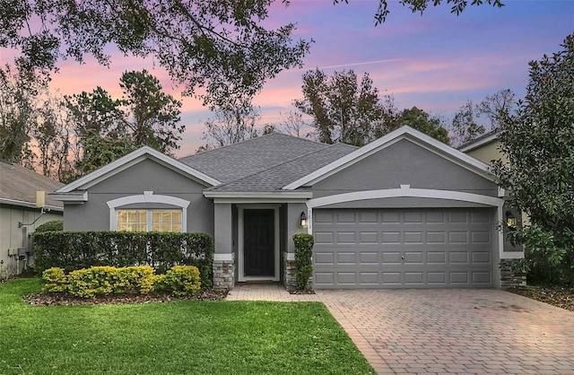 ranch-style house with a lawn and a garage