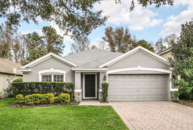 single story home with a garage and a front yard