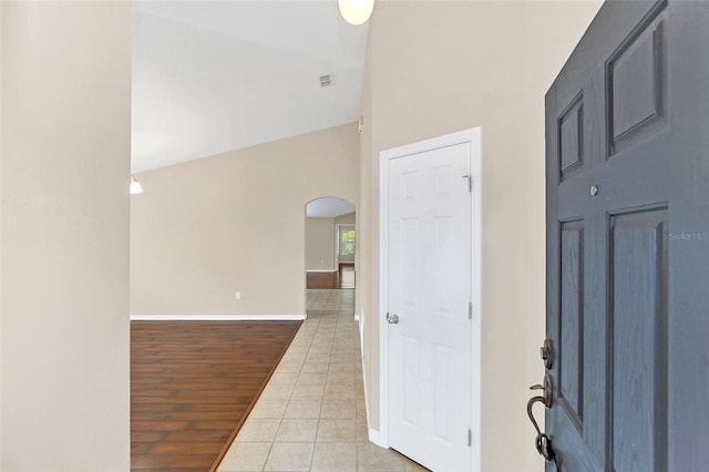 tiled entryway featuring lofted ceiling