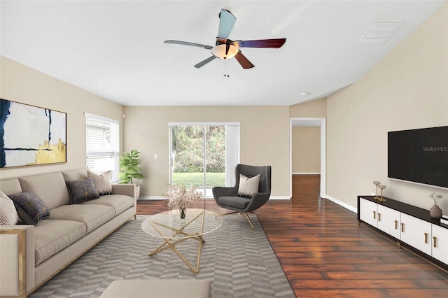 living room with dark hardwood / wood-style flooring and ceiling fan