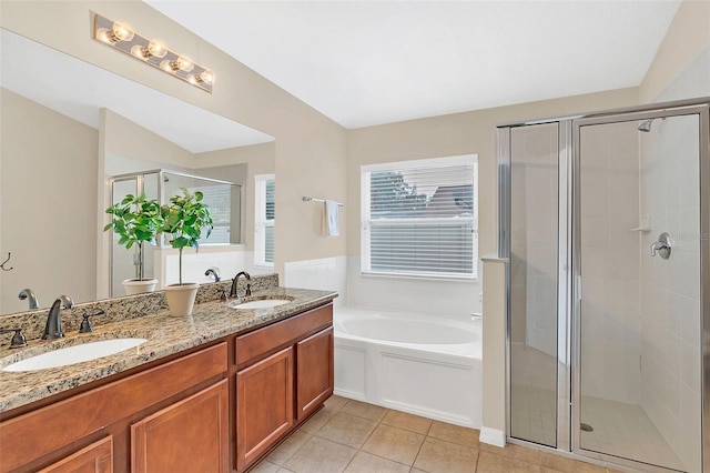 bathroom featuring tile patterned flooring, shower with separate bathtub, and vanity