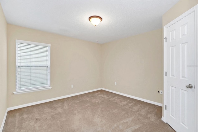 carpeted spare room featuring a textured ceiling