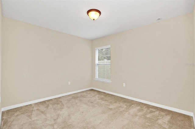 spare room featuring light colored carpet