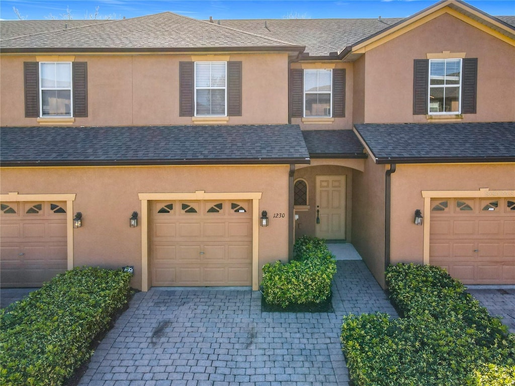 townhome / multi-family property featuring a garage