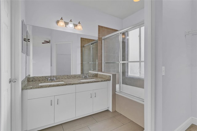 bathroom with tile patterned flooring, vanity, plenty of natural light, and walk in shower