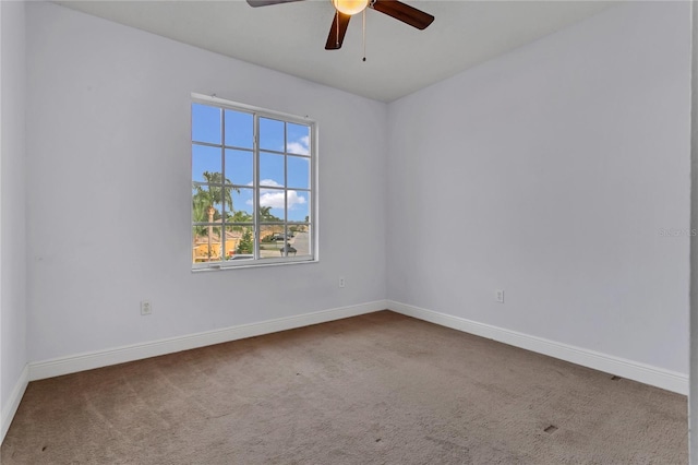 empty room with ceiling fan and carpet