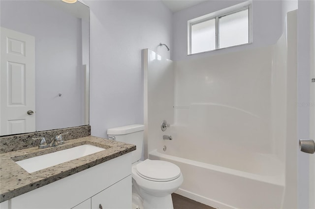 full bathroom with vanity, washtub / shower combination, and toilet