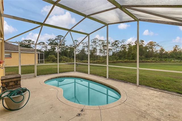 view of swimming pool with a lawn, glass enclosure, and a patio