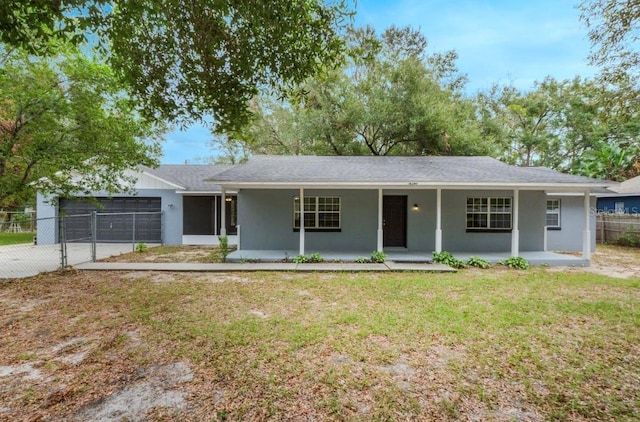 ranch-style house with a front yard, a porch, and a garage