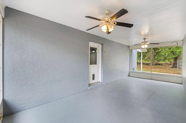 interior space with ceiling fan and concrete floors