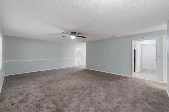 spare room featuring ceiling fan, carpet floors, and a textured ceiling