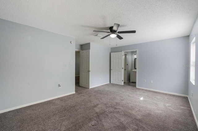 carpeted empty room featuring ceiling fan and a textured ceiling